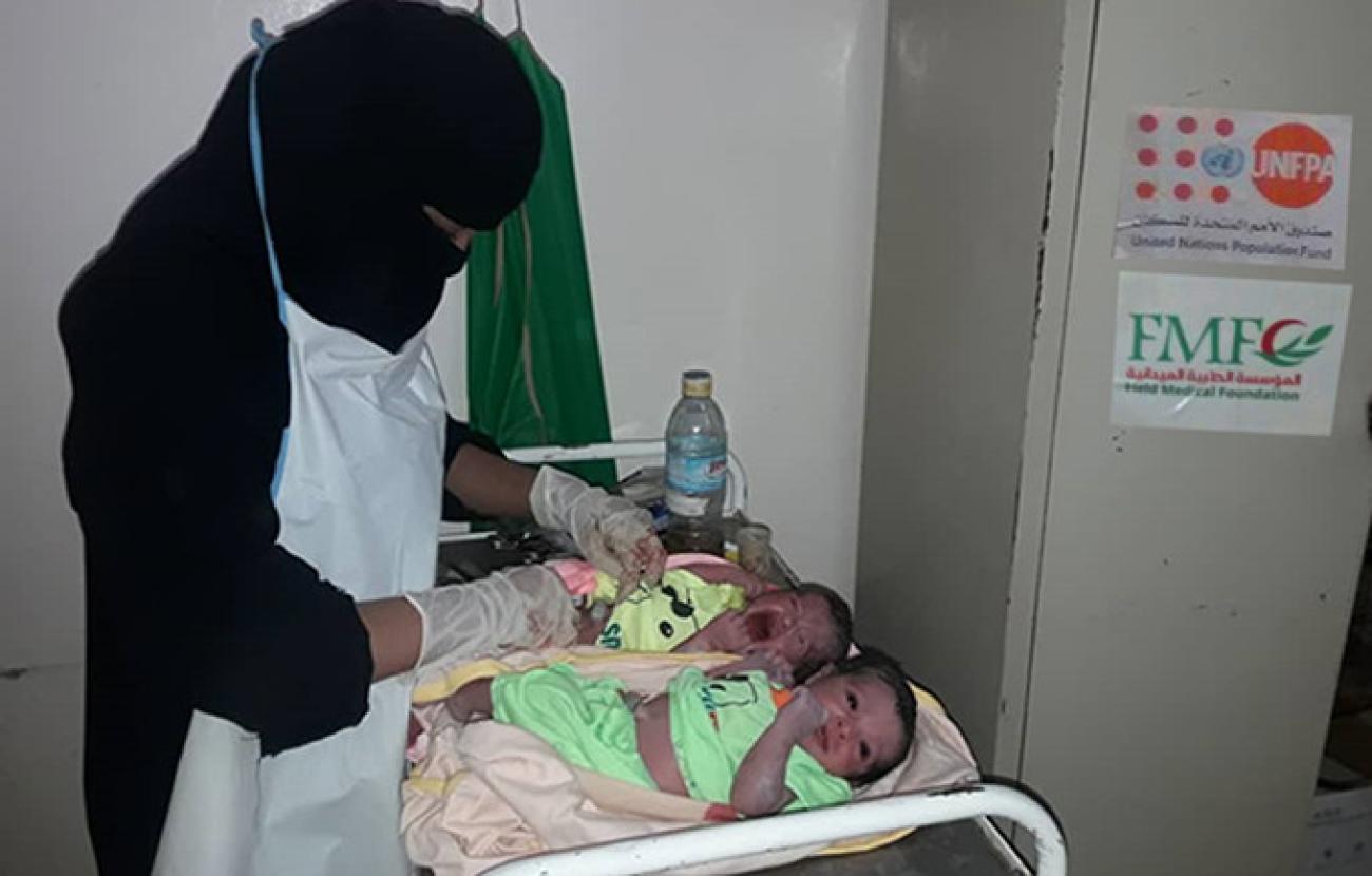 A midwife cares for Mohsina's unexpected twins at Jardan Hospital