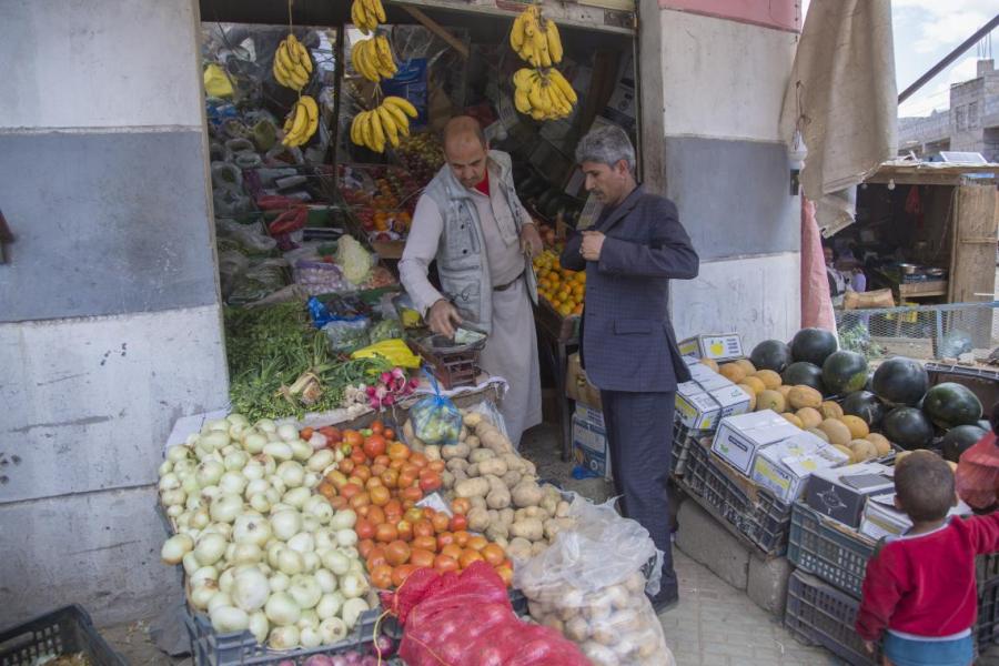 Hamoud buying some vegetables and fruits