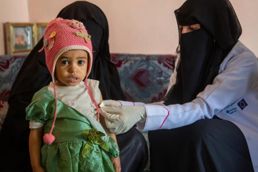 Ibtisam taking baby Safa’s measurements to assess her nutrition status